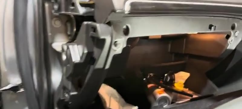 Glove box frame on a Vauxhall Insignia with the four 7mm bolts being removed