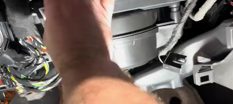 Releasing the top tab on the Vauxhall Insignia pollen filter housing cover