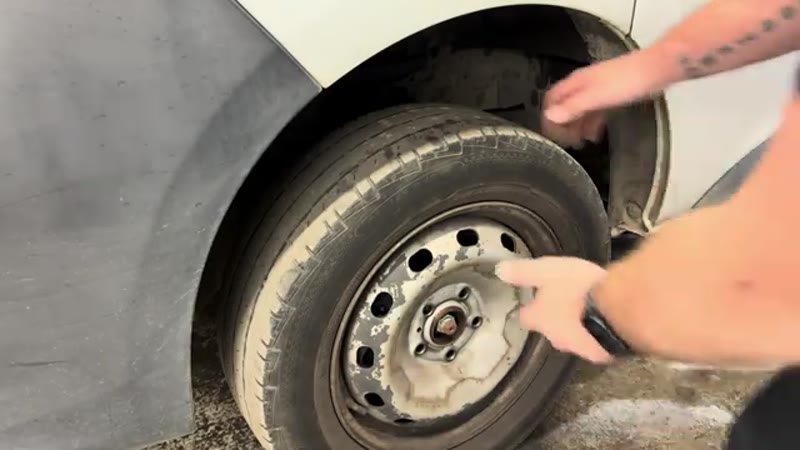 Lifting the front wheel off a Vauxhall Vivaro to reach the shock absorber