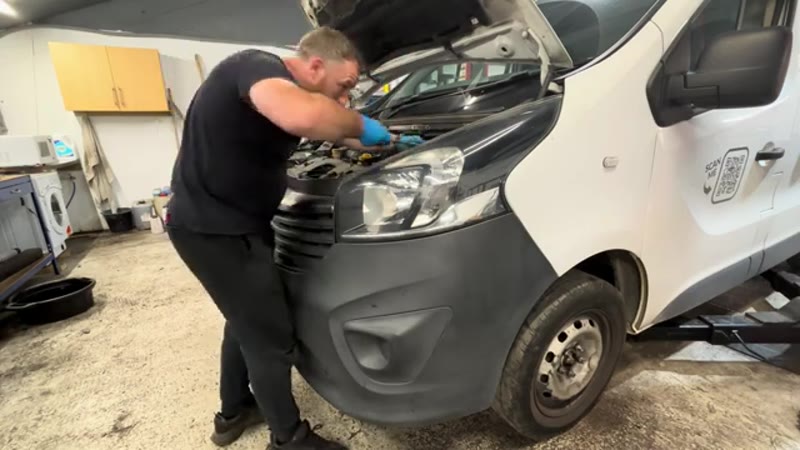 Torquing the strut top nut under the bonnet after lowering the Vauxhall Vivaro