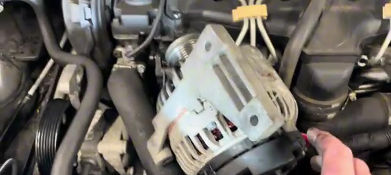 Alternator lifted up and out of the Volvo XC90 engine bay