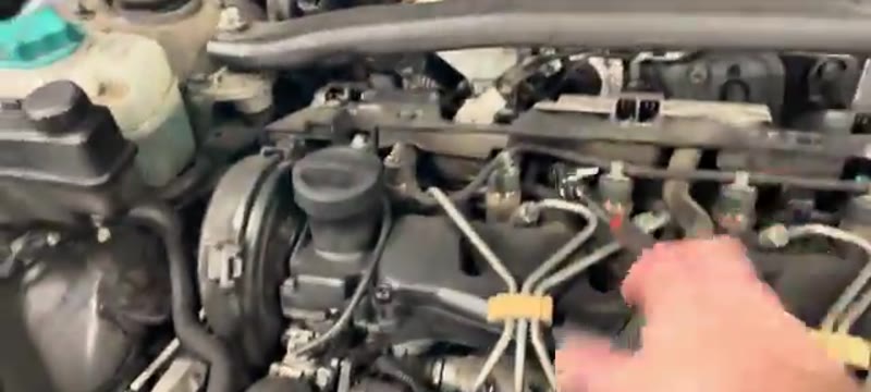 Volvo XC90 engine bay with the plastic engine cover lifted away
