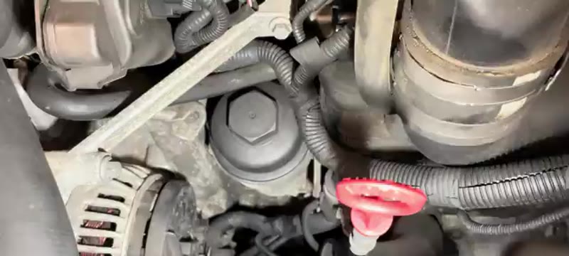 Rear of the Volvo XC90 alternator showing the main terminal and spade connector being disconnected