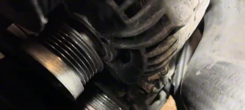 Lower air con pump bolts beneath the Volvo XC90 alternator mounting being slackened