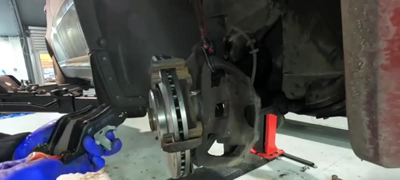 Applying brake grease to the ends of the new Volvo XC90 brake pads before fitting
