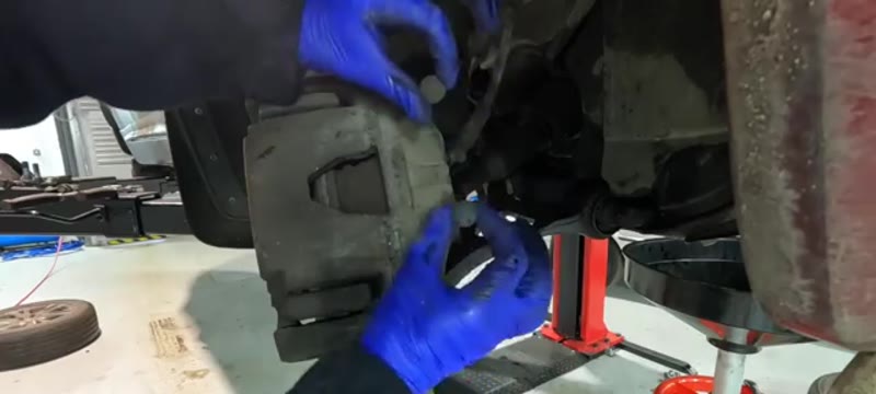 Removing the plastic dust caps from the back of the Volvo XC90 brake caliper
