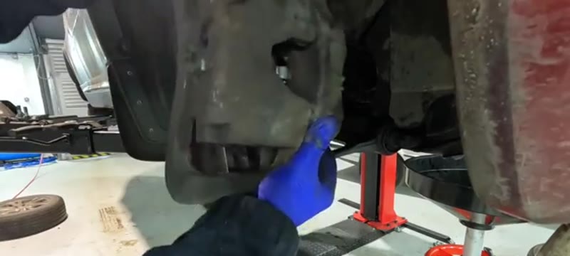 Lifting the heavy Volvo XC90 brake caliper away from the disc
