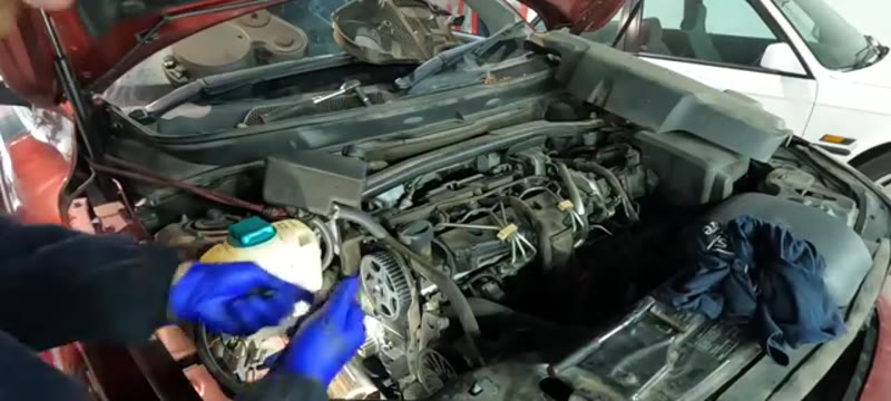 Fitting the new water pump and paper gasket onto the locating dowels on the Volvo XC90 D5