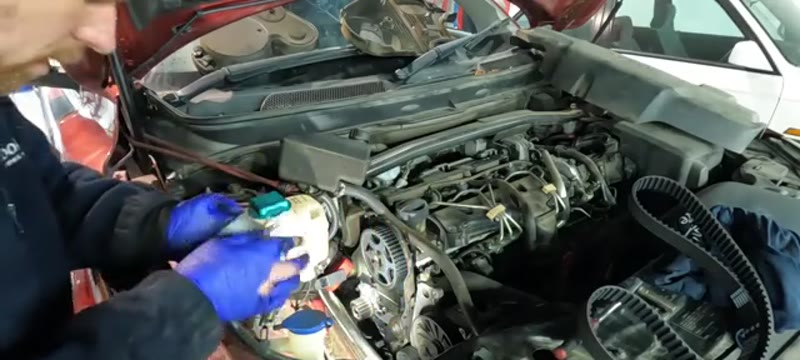 Fitting the new cambelt tensioner with its fresh bolt on the Volvo XC90 D5