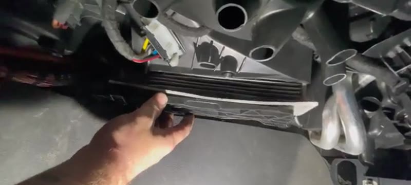 Sliding the pollen filter cover off under the dash of the VW Caddy