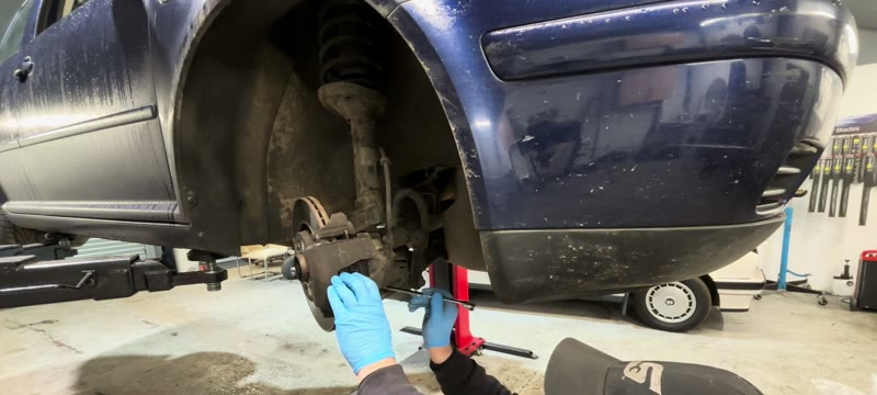 Loosening the 18mm ball joint nut under the driveshaft on the Mk4 Golf hub