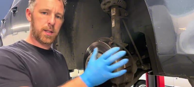 Front wheel removed on a VW Golf Mk6 with the old brake disc and caliper exposed