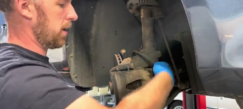 Pulling the slider pin dust caps off the rear of the Golf Mk6 brake caliper