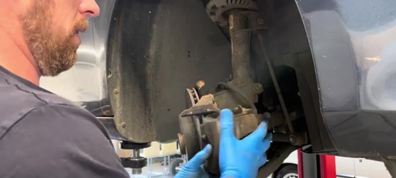 Sliding the brake caliper off the disc on a VW Golf Mk6