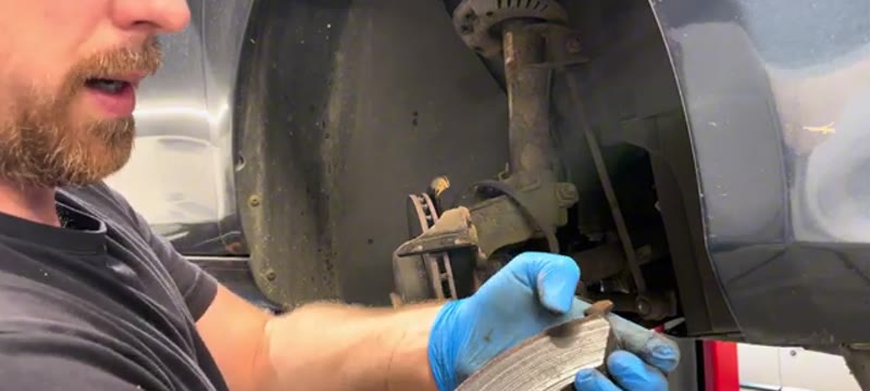 Checking the worn old brake pad removed from the Golf Mk6 caliper