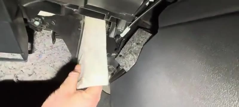 Sliding the old pollen filter out of the housing on the VW Polo