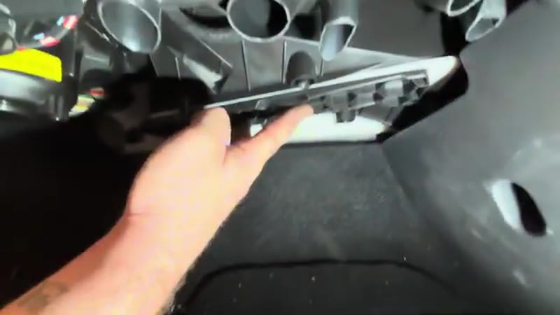 Sliding the filter housing cover back into place on the VW Tiguan