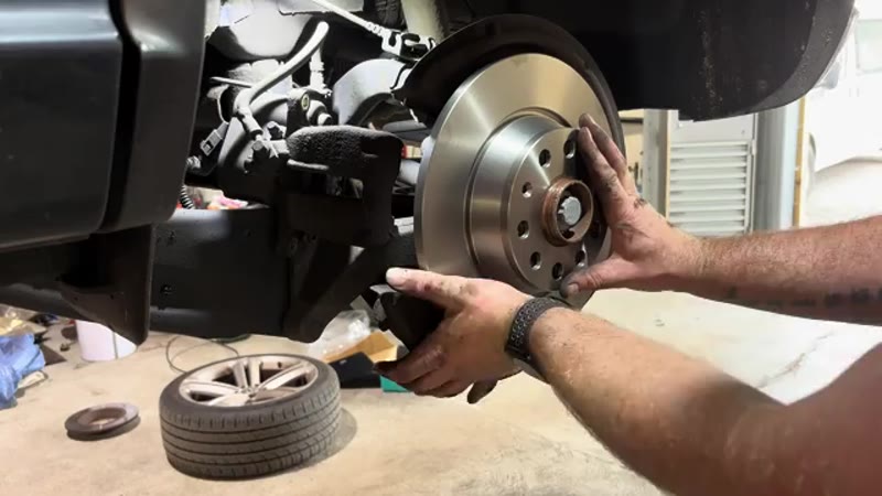 Fitting the new brake disc onto the hub of the VW Tiguan