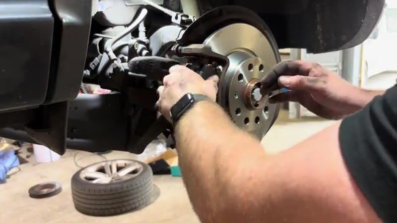Installing the new brake pads into the cleaned carrier on the VW Tiguan