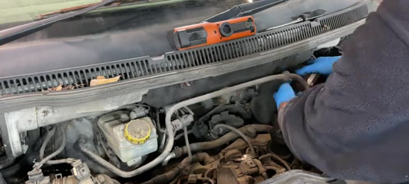 Removing the large intake pipe from the engine bay of a VW Transporter to reach the EGR valve