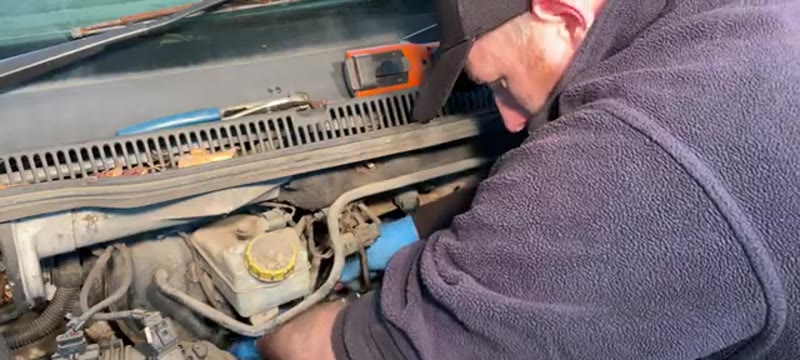 Reaching down the side of the engine to remove the two T30 Torx bolts on a VW Transporter EGR valve