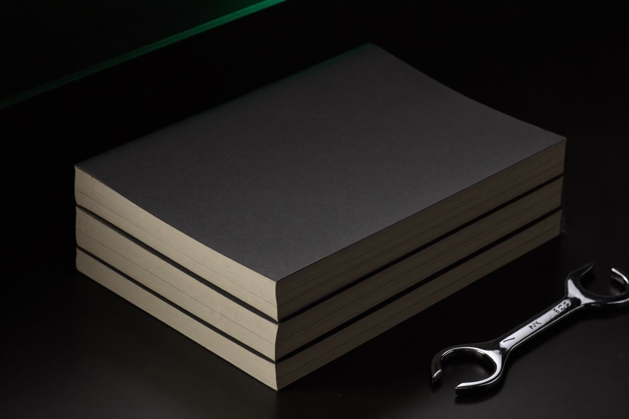 Stack of professional automotive repair manuals on a workbench