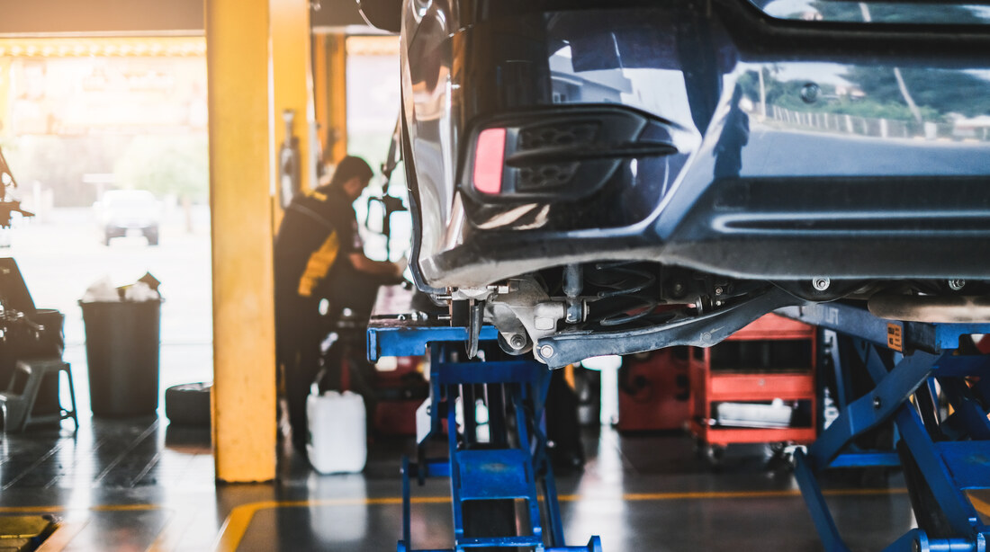 Car raised in a workshop for an MOT inspection