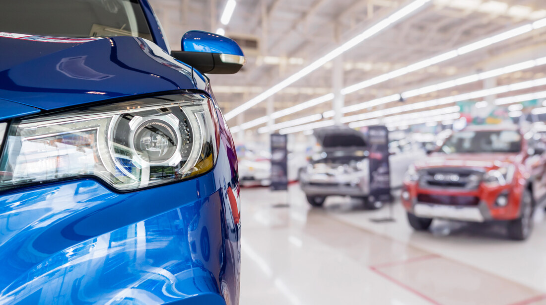 Row of used cars in a dealership showroom