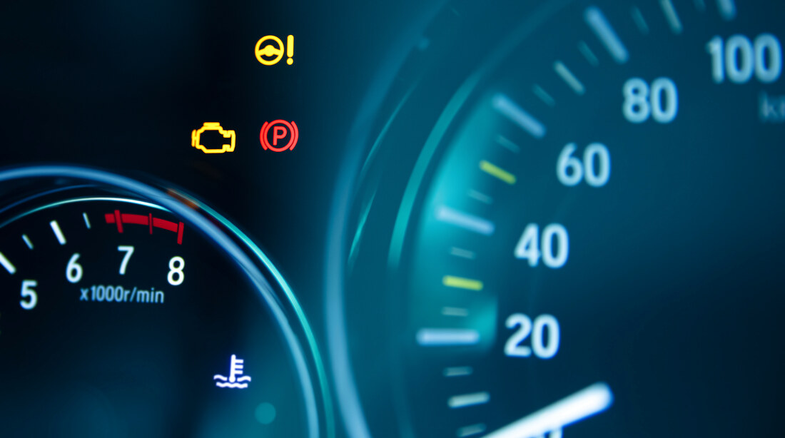 Car dashboard with warning lights illuminated